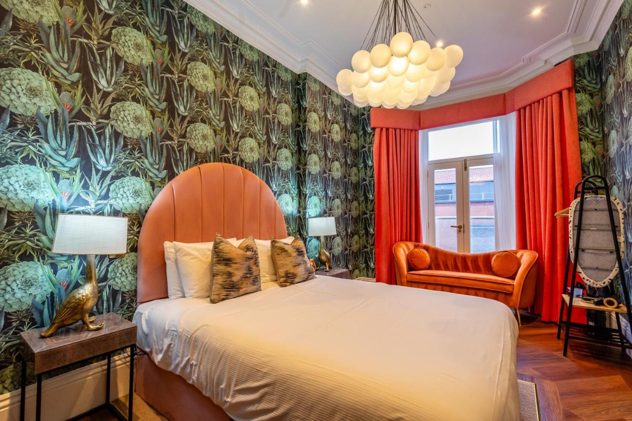 a bedroom with a bed and a chair at 34 Coney Street in York