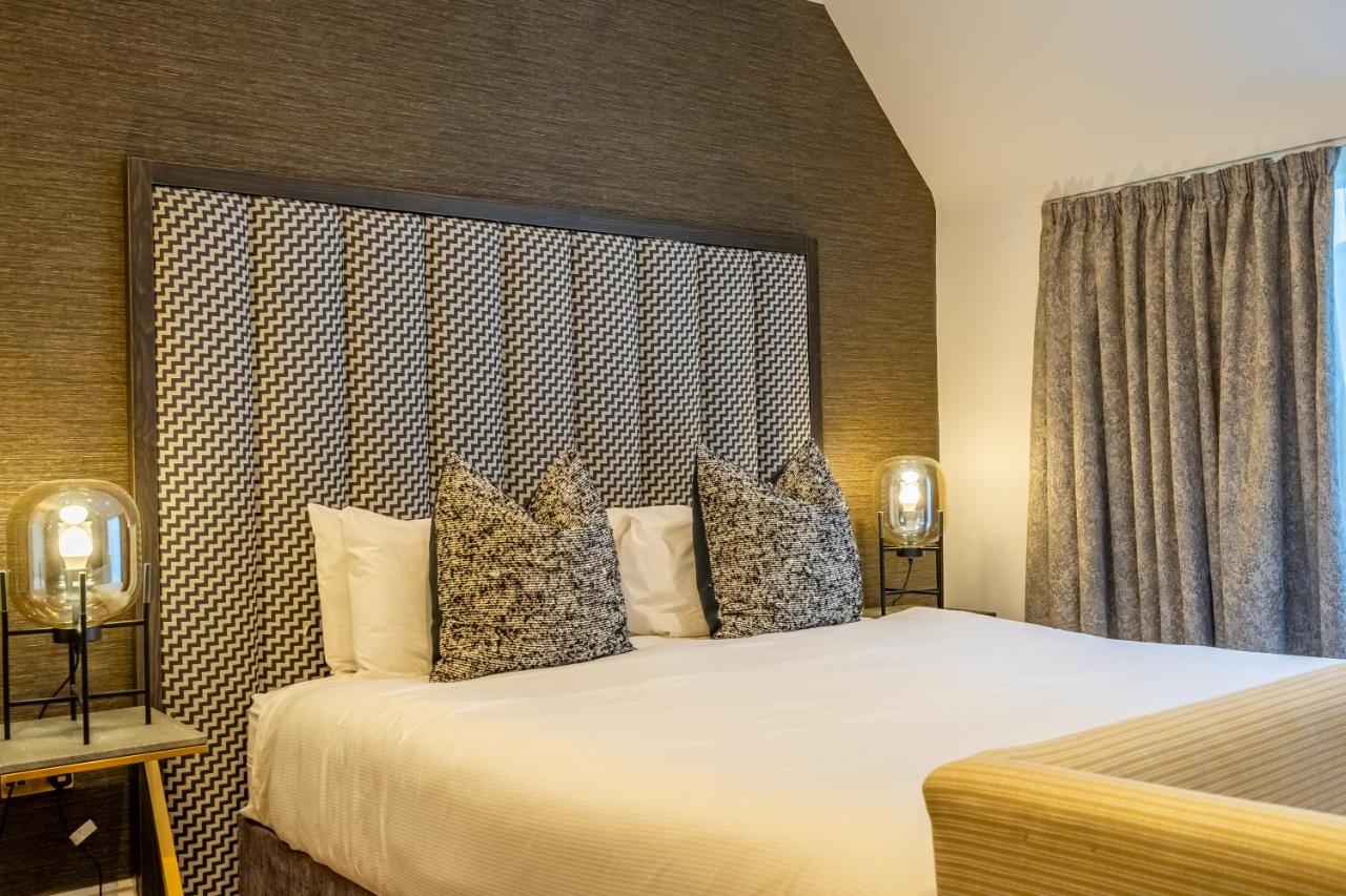 a bedroom with a large bed with a large headboard at 34 Coney Street in York
