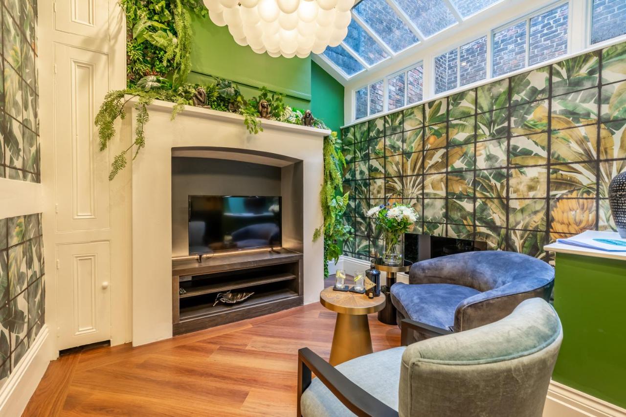 a living room with a fireplace and plants on the wall at 34 Coney Street in York